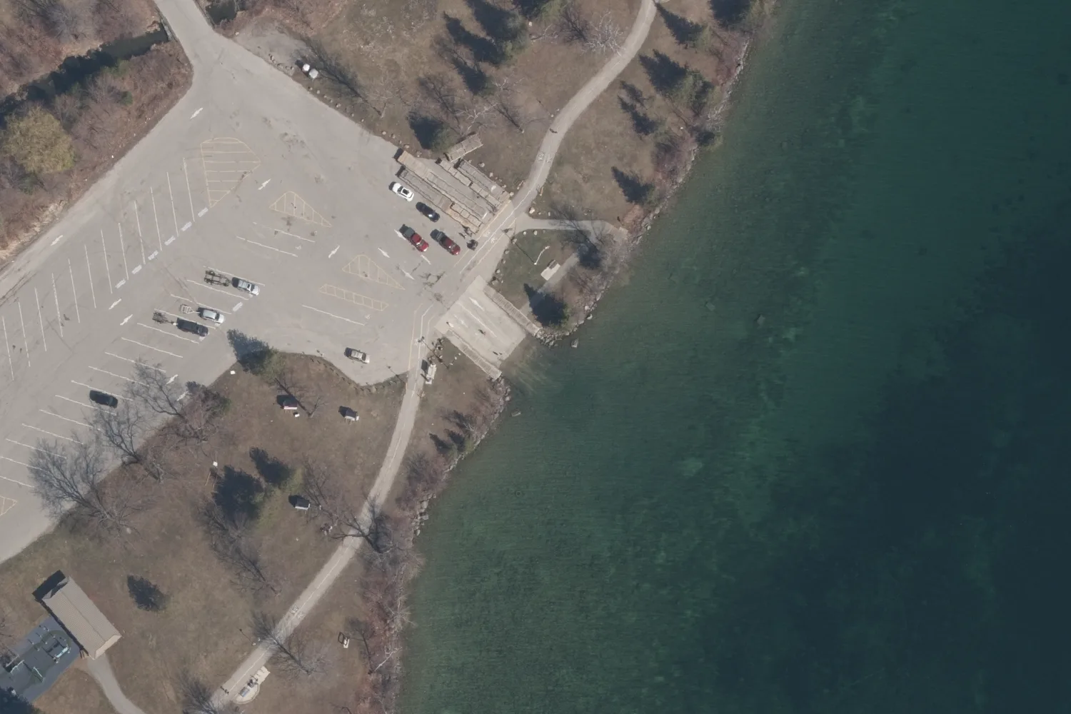Aerial photograph of a boat launch ramp and its trailer parking beside Lake Simcoe