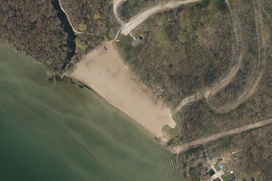 Aerial photograph of a sand beach on Lake Simcoe, pale shallows giving way to deeper green water